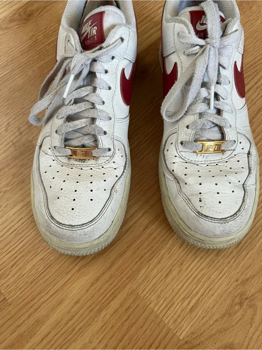 Nike White Sneakers with Red Swoosh Accents
